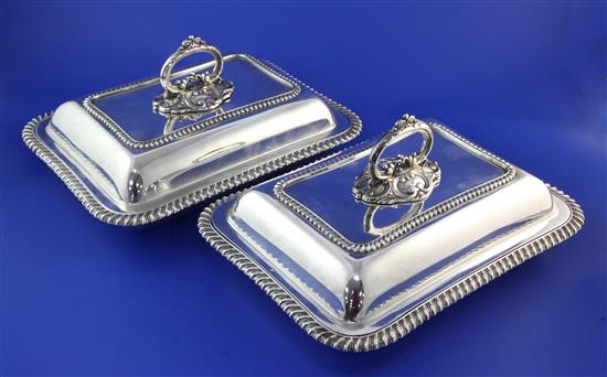 A pair of late Victorian silver rectangular entree dishes and covers with handles, by Mappin & Webb 109 oz.